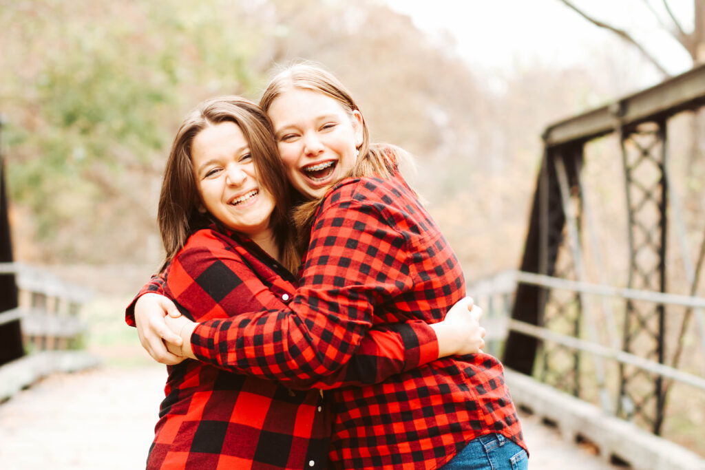 Family photography, two girls hugging, by Whitney L. Wagner